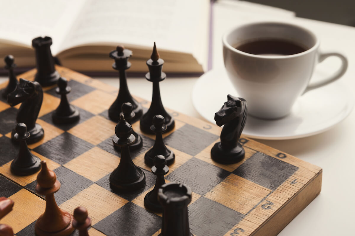 Chess board next to cup of coffee-Mental Wellness-HarborChase Senior Living