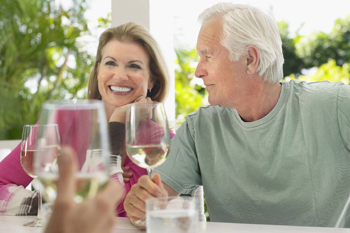 Older couple drinking wine, enjoying retirement