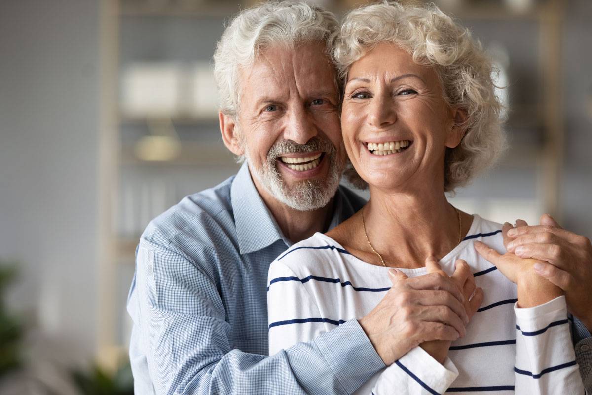 Older couple, close-up, smiling, leaning on one another