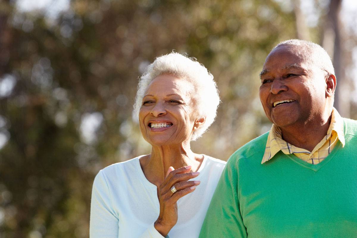 Close-up of older African American couple smiling, walking outside