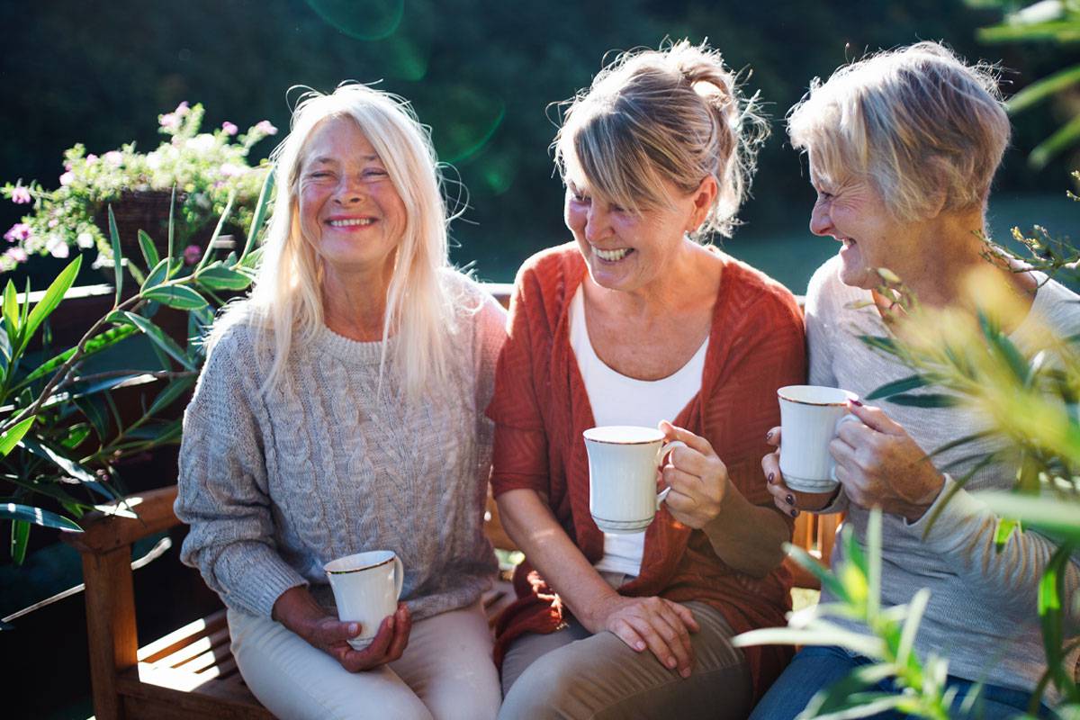 Group of Woman Laughing Over Coffee-Luxury Senior Living in Stuart, Florida