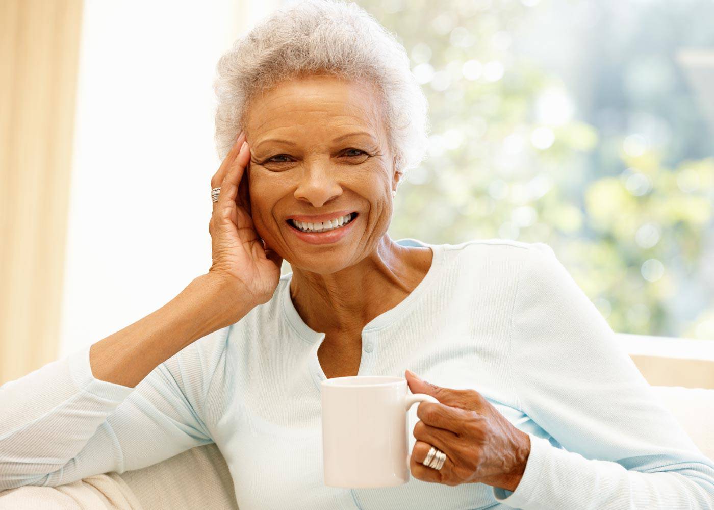Older Woman Smiling with Cup of Coffee_HarborChase Senior Living