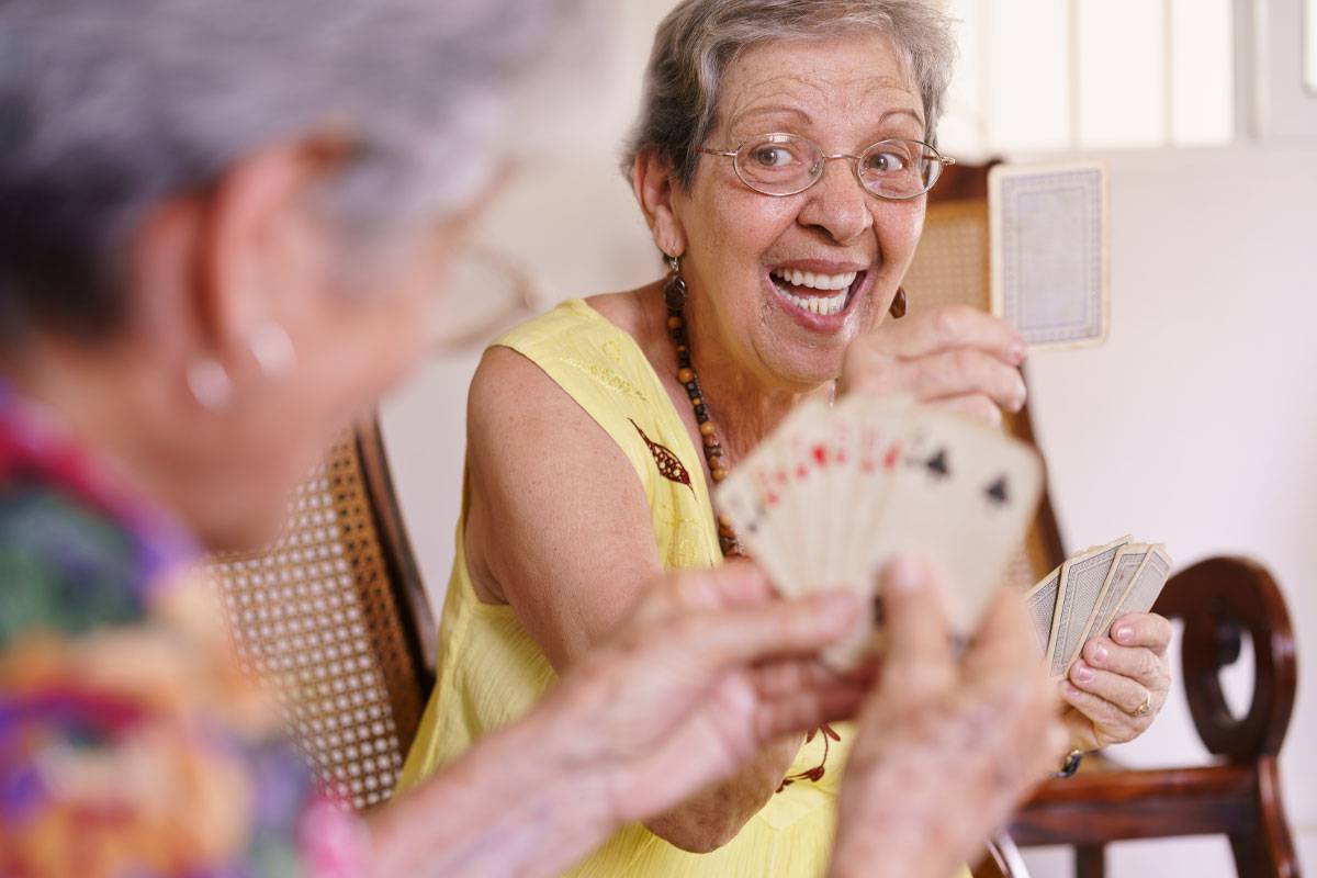Two Older Woman Playing Cards-Dementia Care & Support in Stuart, Florida