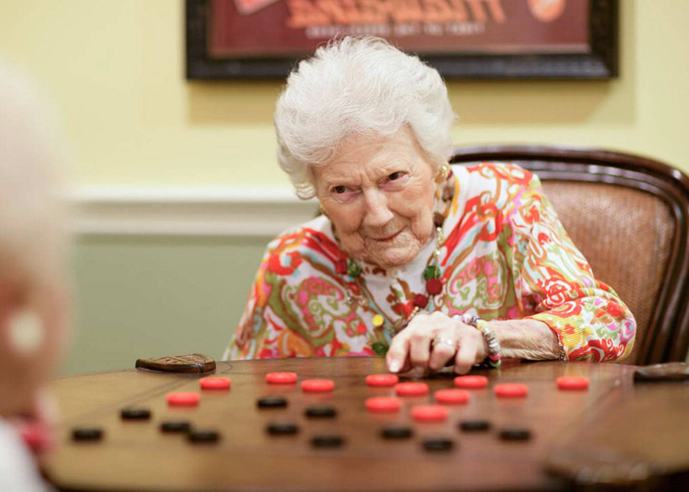 Close up of older woman playing chess