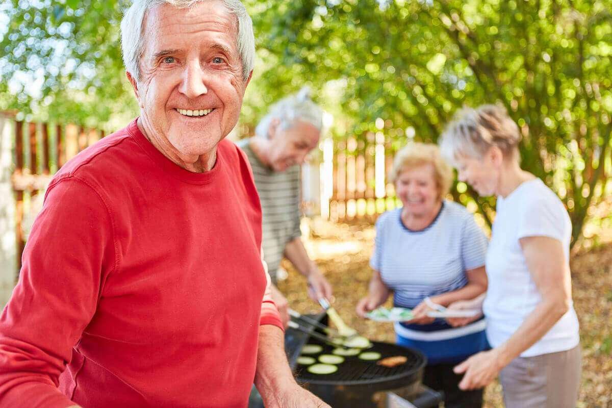 Group of older adults grilling outside-Seasonal produce