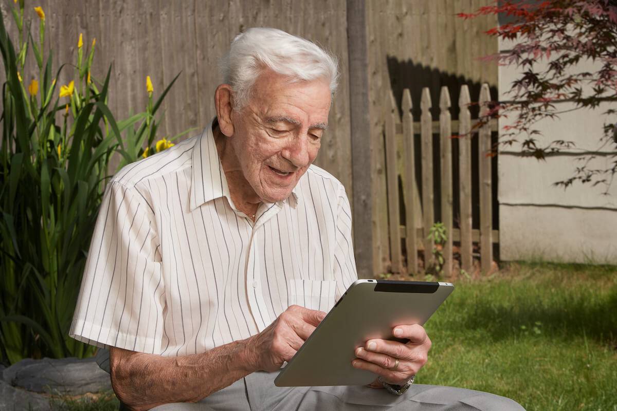 Older Man Looking at Tablet-Dementia Care-HarborChase Senior Living