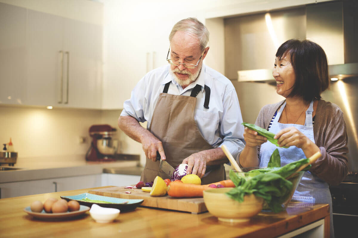 Older couple shopping vegetables, cooking together in kitchen-Food substitutions for comfort food