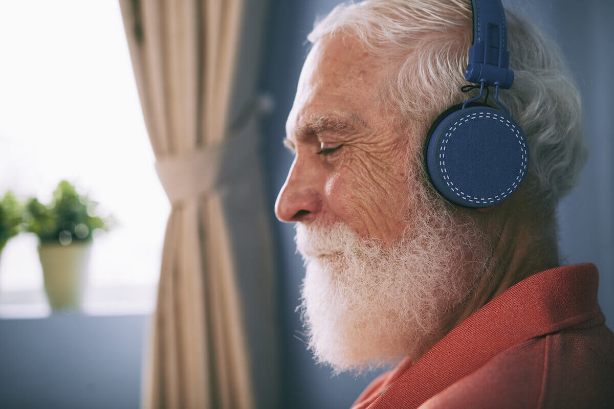 Older man wearing headphones, eyes closed-Music and Dementia