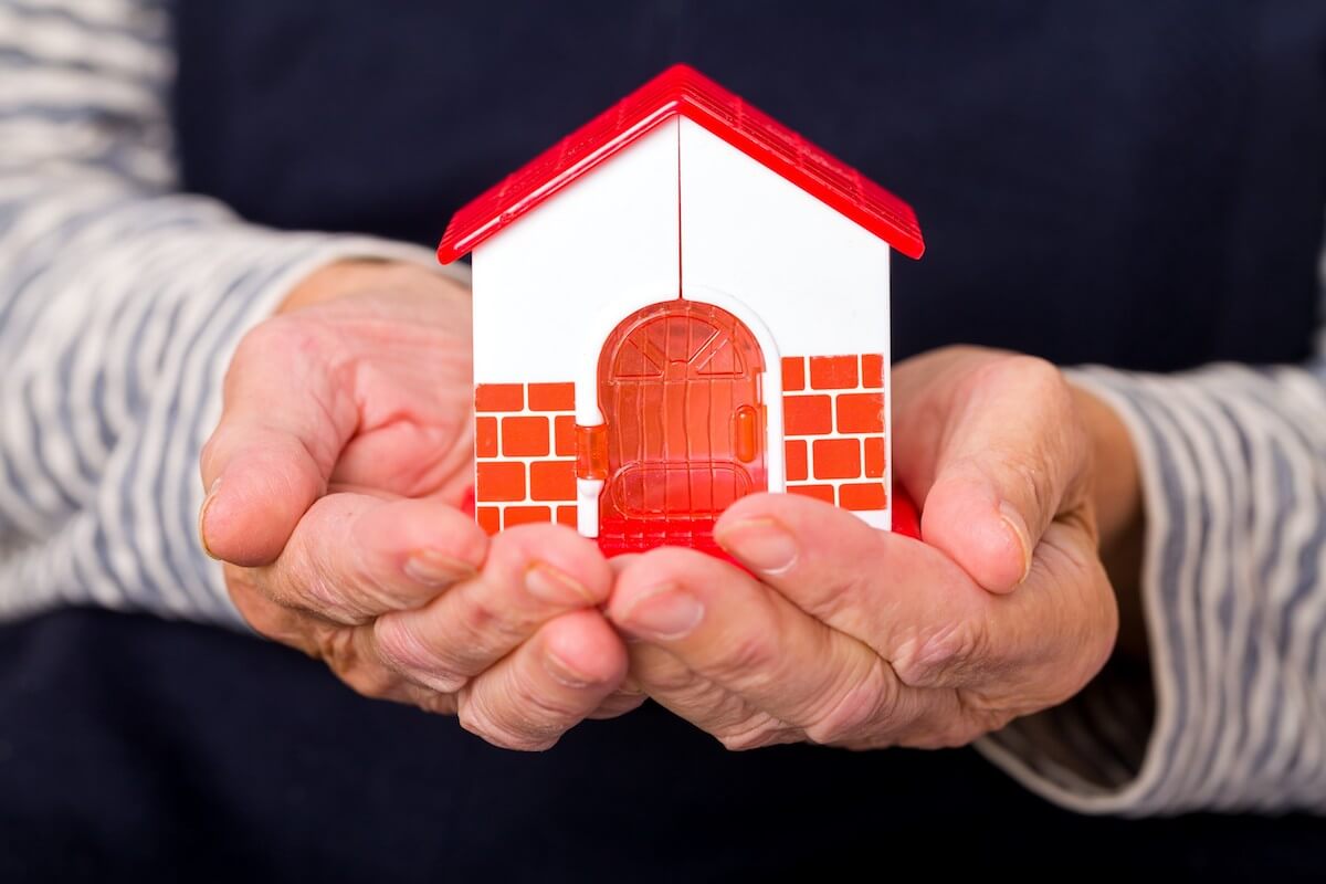 Senior holding plastic house in both hands-Maintaining a home-HarborChase Senior Livin