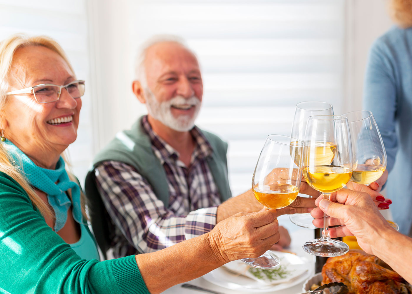 Group of older adults clinking wine glasses