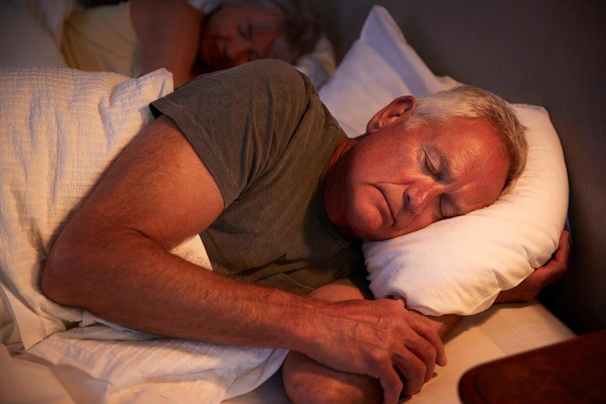 peaceful-senior-man-asleep-in-bed-at-night-HarborChase Senior Living