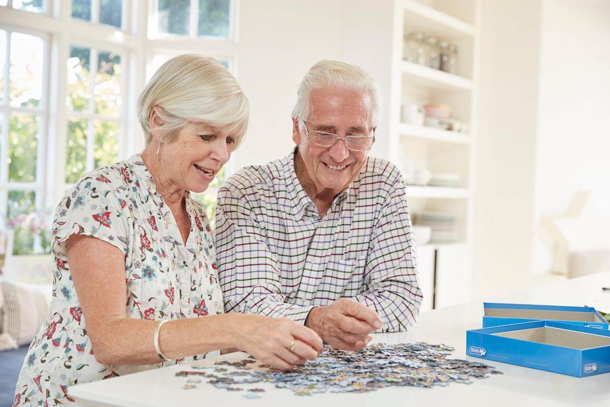 senior-couple-doing-a-jigsaw-puzzle-at-home-HarborChase Senior Living