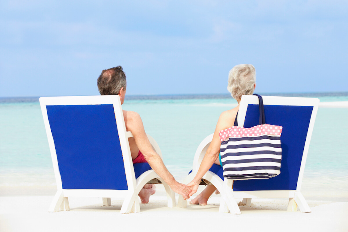 senior-couple-on-beach-relaxing-in-chairs-Florida Senior Living