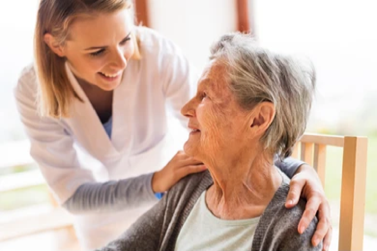Caregiver Smiling of Shoulder of Older Woman