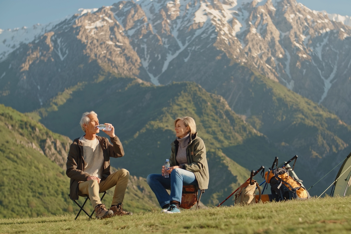 Old,Caucasian,Couple,Taking,A,Rest,On,Top,Of,Mountain,