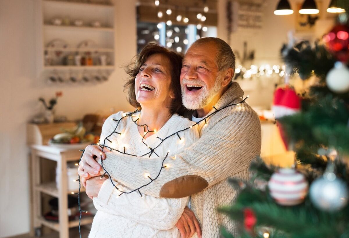 Senior couple hugging in luxury senior living at Christmas time.