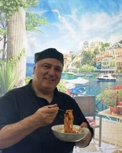 Beloved chef Alberto with a plate of pasta
